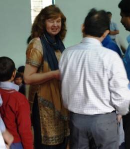 Picture of Cathy at the assembly about to present certificates.