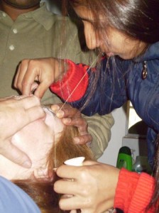 Picture of Cathy undergoing medieval torture - eyebrow plucking 