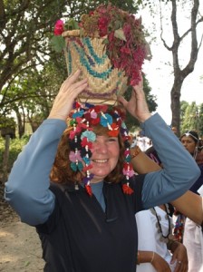 Picture of Cathy holding a Tharu 'head-dress' in place