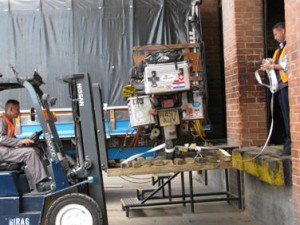 Picture of Bertha who is being lifted up by the fork lift truck and loaded into the bay before being moved for the police inspection. The fork lift truck driver was very proud of his family. 