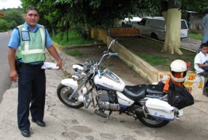 Picture of a policeman and his motorcycle during one of the many vehicle "Can I look at your bike" roadside stops for document checks.
