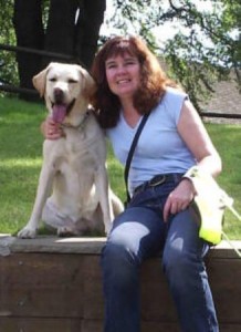 Picture of Cathy sitting with her second guide dog Biscuit